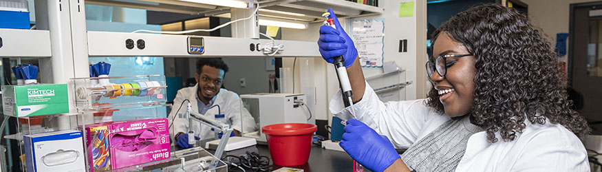 Photo of two students in a lab
